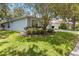Charming single-story home with a well-manicured lawn and lush landscaping at 2910 Red Coat Cir, Brandon, FL 33511