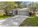 Inviting single-Gathering home with a well-maintained yard, mature landscaping, and an attached two-car garage at 2910 Red Coat Cir, Brandon, FL 33511