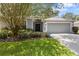Charming single-story home boasts a well-manicured lawn, mature landscaping, and a two-car garage at 2910 Red Coat Cir, Brandon, FL 33511