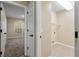 Hallway leading to a laundry room and a bedroom, offering convenience and functionality at 2910 Red Coat Cir, Brandon, FL 33511