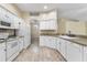 Bright kitchen with white cabinets, tile backsplash and wood-look floors at 2910 Red Coat Cir, Brandon, FL 33511