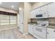 White kitchen features updated appliances and a bright window at 2910 Red Coat Cir, Brandon, FL 33511