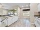 Kitchen island featuring stainless sink and view into the adjoining dining area at 2910 Red Coat Cir, Brandon, FL 33511