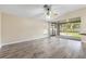 Spacious room featuring wood-look flooring, and sliding doors to a screened-in patio at 2910 Red Coat Cir, Brandon, FL 33511