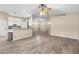 The living room is open to the kitchen area and features wood grain floors and a ceiling fan at 2910 Red Coat Cir, Brandon, FL 33511