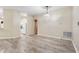 Open-concept living room with wood-look floors leading to the kitchen and dining area at 2910 Red Coat Cir, Brandon, FL 33511