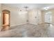 Spacious living area with wood-look floors, neutral paint, and an arched entryway at 2910 Red Coat Cir, Brandon, FL 33511
