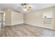 Light-filled living room with wood-look floors, neutral walls, and bright window at 2910 Red Coat Cir, Brandon, FL 33511