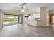 Bright living room features sliding glass doors to the screened patio and open to the kitchen at 2910 Red Coat Cir, Brandon, FL 33511