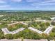 Scenic aerial view of a condominium complex surrounded by verdant trees and well-maintained green spaces at 3062 Eastland Blvd # 311, Clearwater, FL 33761