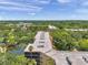 Scenic aerial view of complex with a roof, water, bridge, and surrounding lush greenery at 3062 Eastland Blvd # 311, Clearwater, FL 33761