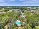 An aerial view of a community pool nestled among trees at 3062 Eastland Blvd # 311, Clearwater, FL 33761