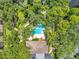 Stunning aerial view of pool and clubhouse surrounded by lush green trees at 3062 Eastland Blvd # 311, Clearwater, FL 33761