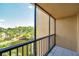Balcony view with a view of a lake and trees and bridge, accessible through screened windows at 3062 Eastland Blvd # 311, Clearwater, FL 33761