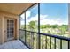 This balcony offers views of a serene lake, lush greenery, and a clear sky with palm trees at 3062 Eastland Blvd # 311, Clearwater, FL 33761