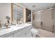 Bright bathroom featuring a shower with glass doors, a toilet, and a spacious sink at 3062 Eastland Blvd # 311, Clearwater, FL 33761