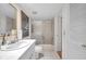 Bright bathroom featuring a spacious sink, a toilet, and a shower with glass doors at 3062 Eastland Blvd # 311, Clearwater, FL 33761
