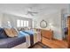 Bright bedroom features a double bed, hardwood floors, and a ceiling fan at 3062 Eastland Blvd # 311, Clearwater, FL 33761