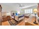 Bedroom with hardwood floors featuring a double bed, a ceiling fan, and a window at 3062 Eastland Blvd # 311, Clearwater, FL 33761