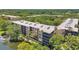 An aerial of an apartment complex surrounded by lush greenery next to a serene body of water at 3062 Eastland Blvd # 311, Clearwater, FL 33761