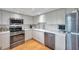 Bright kitchen with stainless steel appliances and white cabinetry at 3062 Eastland Blvd # 311, Clearwater, FL 33761