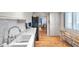 Spacious kitchen features white cabinets and stainless steel dishwasher at 3062 Eastland Blvd # 311, Clearwater, FL 33761