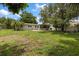 Sprawling backyard with lush green lawn and mature trees at 4321 S Thatcher Ave, Tampa, FL 33611