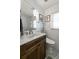 Modern bathroom with wood vanity, white marble tile, and decorative wall art at 4321 S Thatcher Ave, Tampa, FL 33611