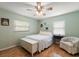 Cozy bedroom with hardwood floors, bright windows, and comfortable decor at 4321 S Thatcher Ave, Tampa, FL 33611