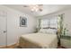 Bright bedroom featuring a ceiling fan, hardwood floors and colorful floral curtains at 4321 S Thatcher Ave, Tampa, FL 33611