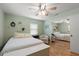 Charming bedroom with mirrored closet doors, hardwood flooring, and bright windows at 4321 S Thatcher Ave, Tampa, FL 33611