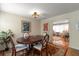 Dining room features a wood table, classic chairs, decorative art, and an open doorway to the living room at 4321 S Thatcher Ave, Tampa, FL 33611