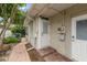 Exterior side door with brick steps, white trim, and convenient access to the yard at 4321 S Thatcher Ave, Tampa, FL 33611