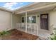 Inviting front porch with white railings, a decorative front door, and seating for guests at 4321 S Thatcher Ave, Tampa, FL 33611