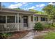 Charming home showcasing a cute porch with white railings and a decorative front door at 4321 S Thatcher Ave, Tampa, FL 33611