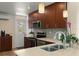 Modern kitchen features stainless appliances, stylish cabinets, mosaic backsplash, and a double basin sink at 4321 S Thatcher Ave, Tampa, FL 33611