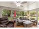 Bright sunroom with cozy seating, tiled floor and serene backyard views at 4321 S Thatcher Ave, Tampa, FL 33611