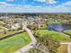Beautiful aerial view of homes in a community with mature trees, a golf course, and a large pond at 4515 Bent Tree Blvd, Sarasota, FL 34241