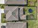 Drone shot of the home's roof and backyard with a trampoline surrounded by a fence at 4515 Bent Tree Blvd, Sarasota, FL 34241