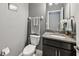 Half-bathroom with granite countertop, modern fixtures, and neutral gray walls at 4515 Bent Tree Blvd, Sarasota, FL 34241