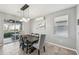 Elegant dining room with a modern chandelier, access to the patio, and neutral decor at 4515 Bent Tree Blvd, Sarasota, FL 34241