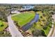 Scenic golf course view with a stream, trees, and the clubhouse in the distance at 4515 Bent Tree Blvd, Sarasota, FL 34241