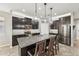 Stylish kitchen featuring dark cabinets, stainless steel appliances, and granite countertops at 4515 Bent Tree Blvd, Sarasota, FL 34241