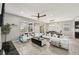 Open-concept living room with tiled floors, modern furniture, and access to dining area at 4515 Bent Tree Blvd, Sarasota, FL 34241