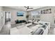 Modern living room featuring sleek black and white furniture, a ceiling fan, and a large window at 4515 Bent Tree Blvd, Sarasota, FL 34241