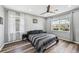 This is a spacious bedroom featuring hardwood floors, a ceiling fan, and two windows at 4515 Bent Tree Blvd, Sarasota, FL 34241