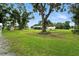 Lush backyard featuring mature trees and well-maintained grass, offering a private and serene outdoor space at 4708 Bugg Rd, Plant City, FL 33567