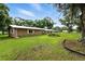 Spacious backyard with mature trees, green grass, and a view of the side of the house at 4708 Bugg Rd, Plant City, FL 33567