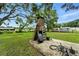 Large backyard featuring a brick chimney surrounded by grass and mature trees providing a serene environment at 4708 Bugg Rd, Plant City, FL 33567