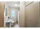 Bathroom featuring a pedestal sink, toilet, shower, and white wall tiles at 4708 Bugg Rd, Plant City, FL 33567